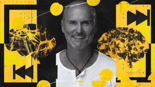 A smiling man in a white shirt is centered in an abstract background featuring yellow and black graphics of interconnected neural networks and brain illustrations, symbolizing wisdom management.