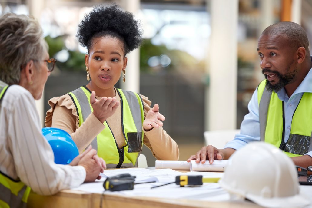 Office meeting, planning and engineering people in teamwork, collaboration and ideas for blueprint design. Project management, floor plan questions and manager, woman or group talking of architecture